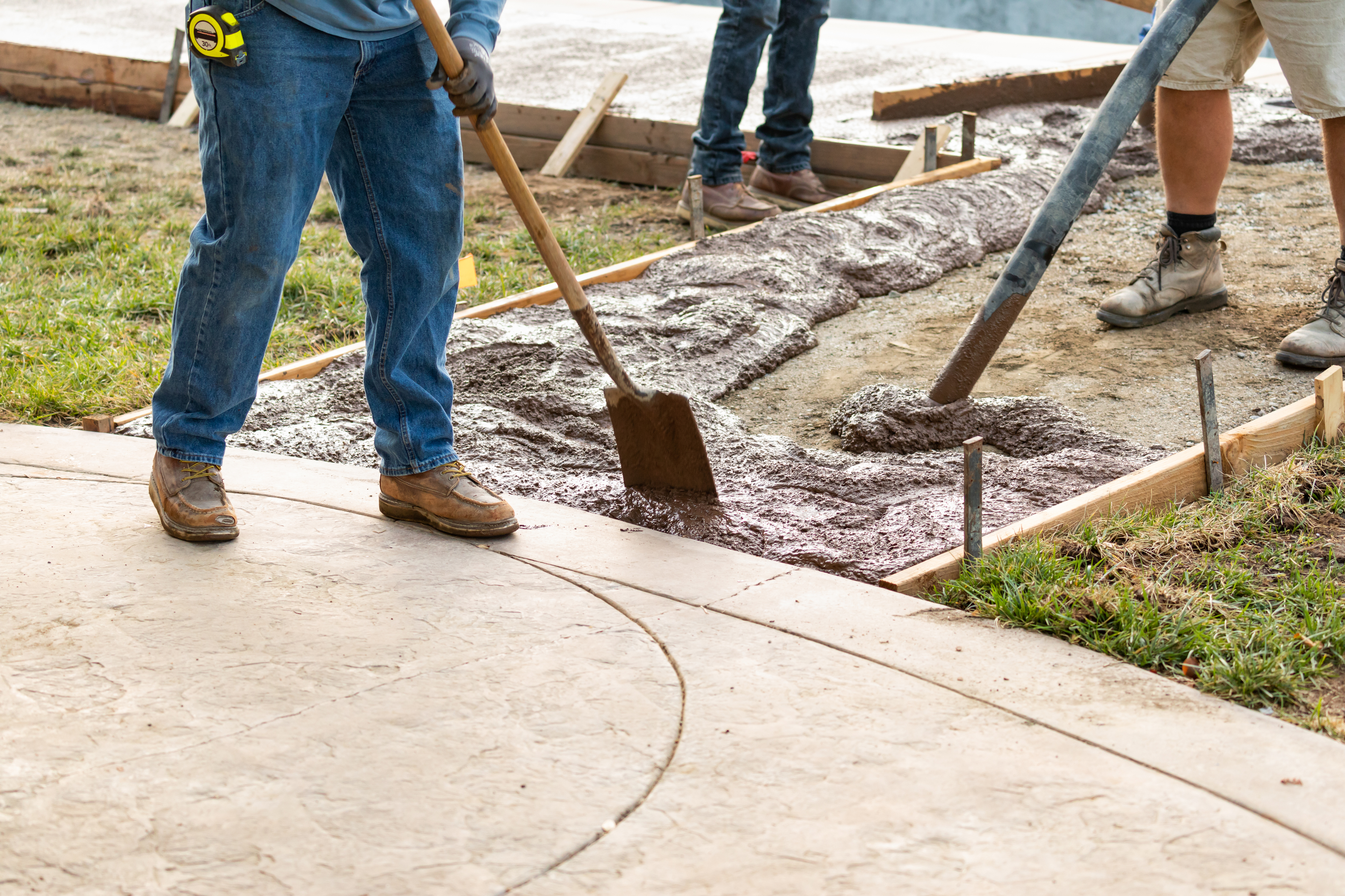 close up of people laying concrete