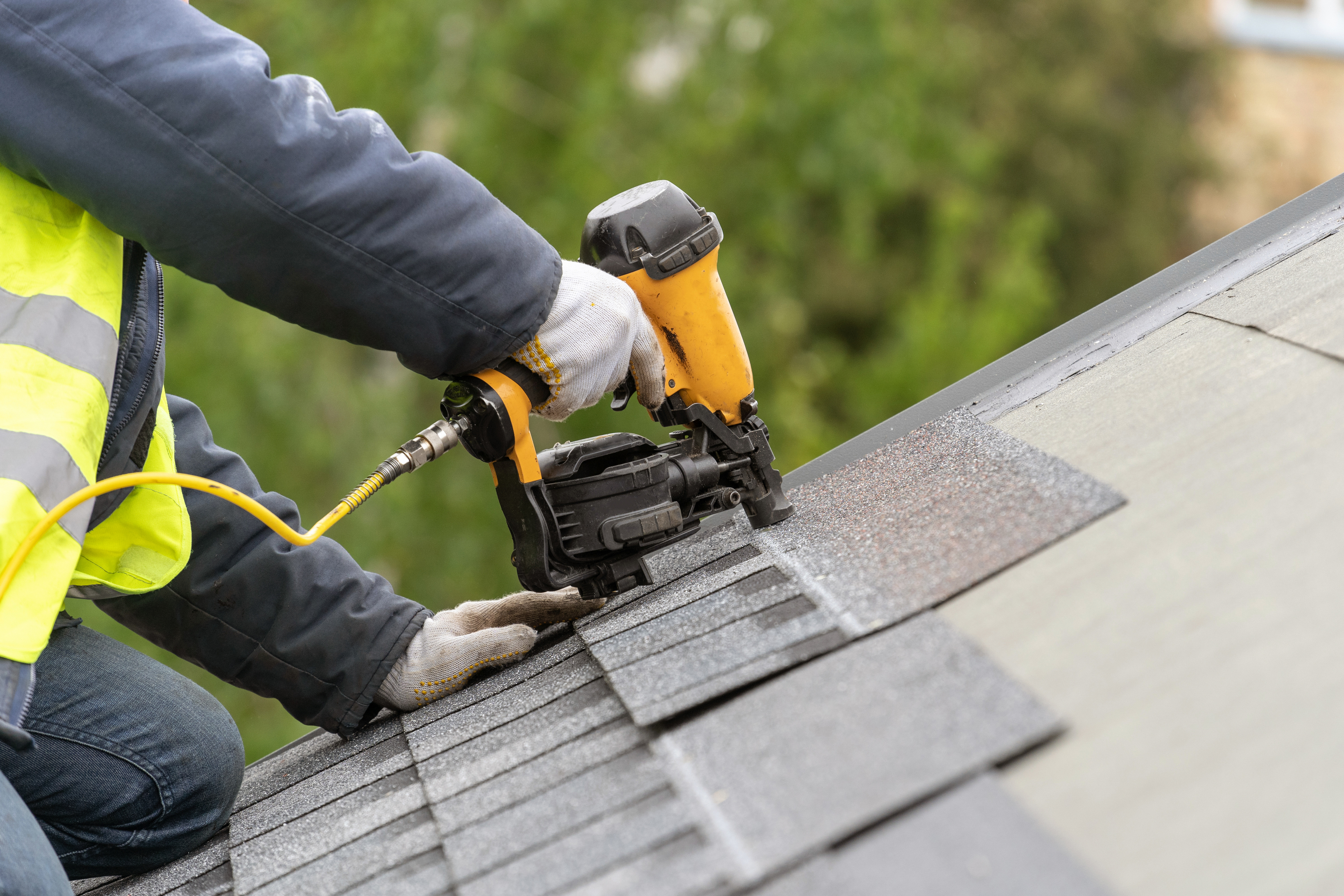 close up of a person repairing a roof