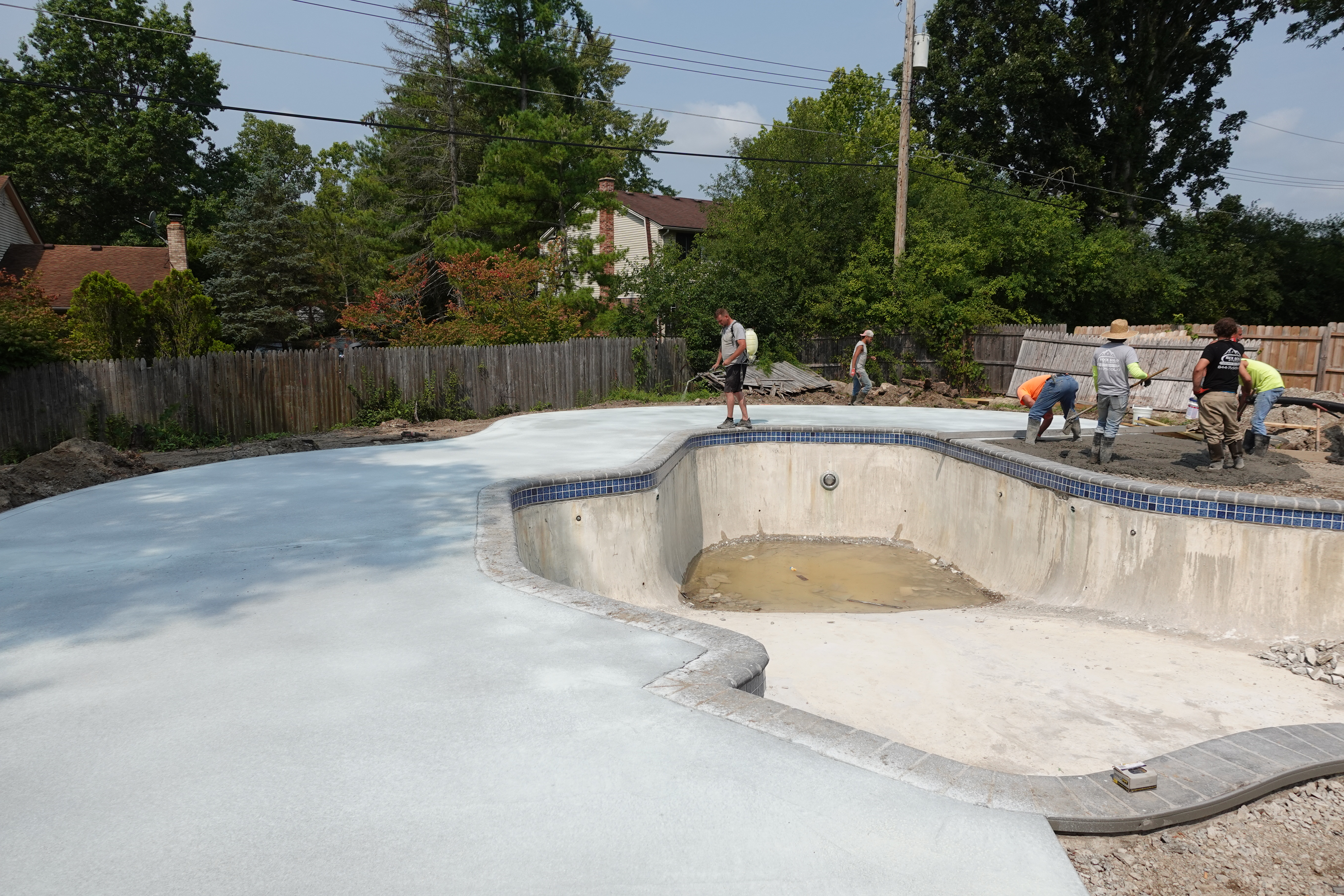 concrete work around an inground pool